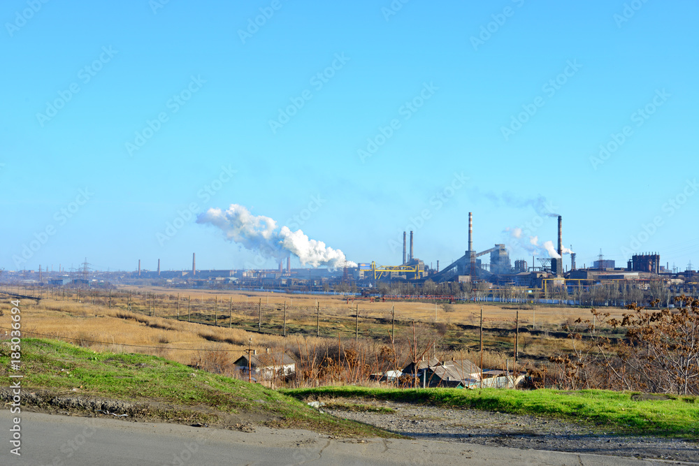 Smoke from the industrial plant over the city in the clouds. Factory smoke tubes. Polluted air Smoke from the industrial plant over the city in the clouds. Factory smoke tubes. Polluted air