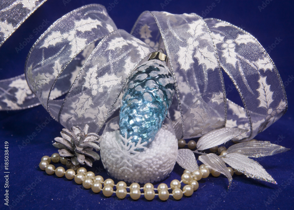 Fototapeta premium The glass New Year's cone and a New Year's tape on a blue background