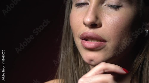 Beautiful brunette with shiny earrings showing sexually arousal