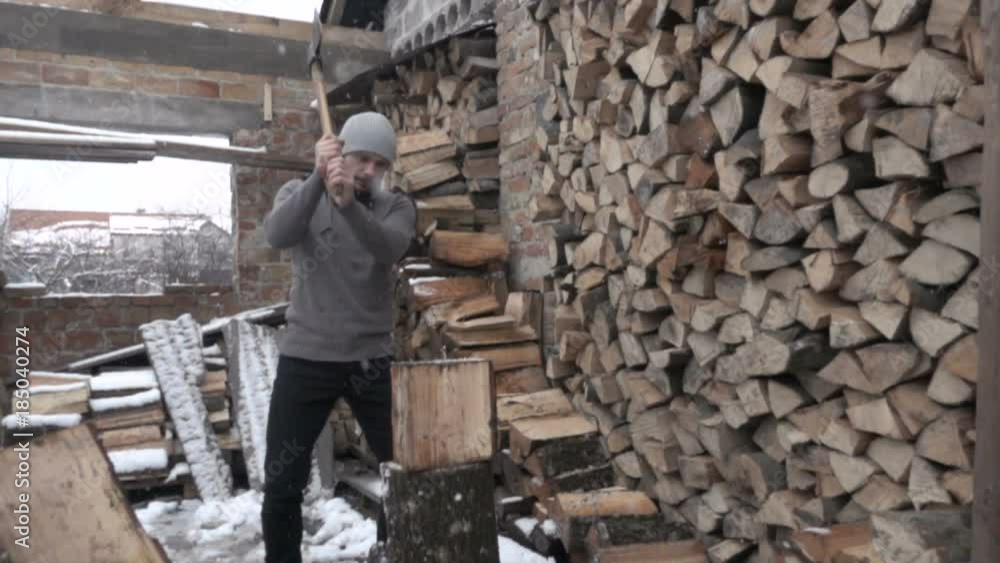 A man cuts wood logs with an ax. Felling of trees. A pile of sawn firewood. Chop wood with an ax. A man cuts wood logs with an ax. Felling of trees. A pile of sawn firewood. Chop wood with an ax.