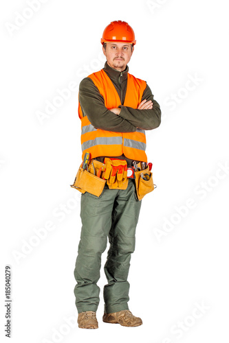 construction worker with arms crossed in a helmet  in orange security vest © kaninstudio