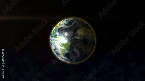 The planet Earth in space is illuminated by the rays of the Sun.