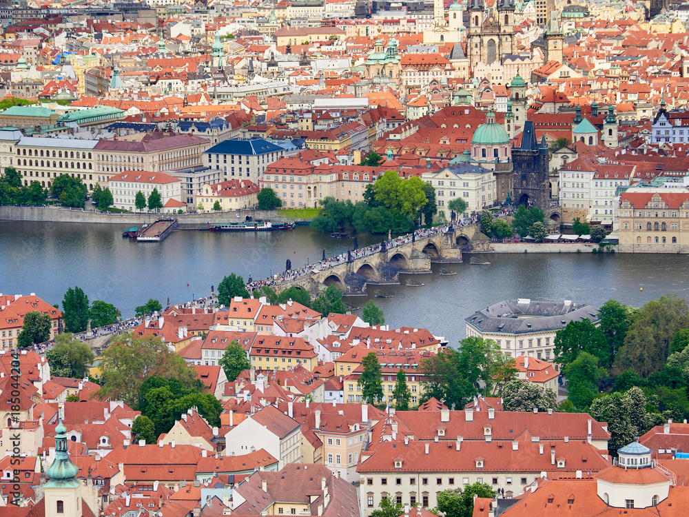 An aerial view of Prague with it's red rooftops on a sunny day in the Czech Republic.