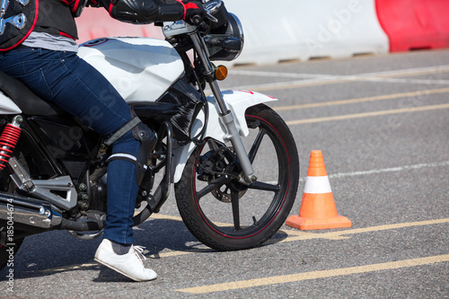 Close up view at training motorbike with person practicing on motor-vehicle proving ground