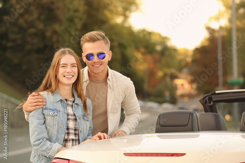 Happy young couple standing...