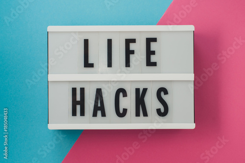 life hacks - text on a display on blue and pink bright background.