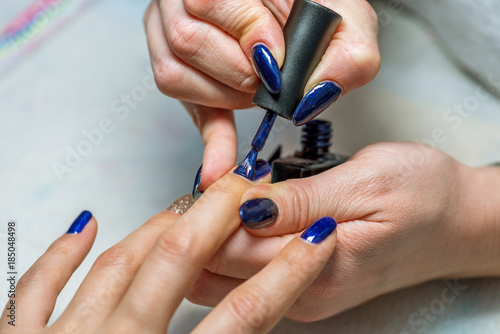 Manicure treatment at nail salon.