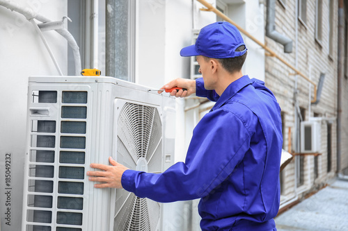 Male technician repairing c...