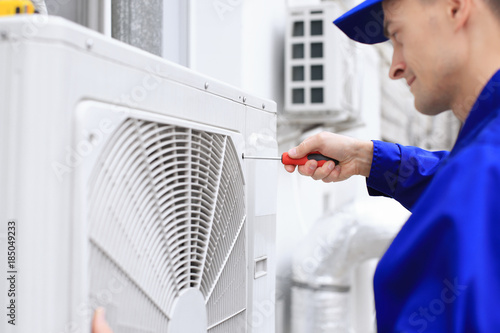 Male technician repairing c...