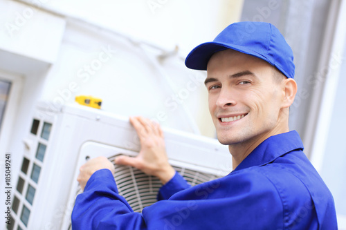 Male technician repairing c...