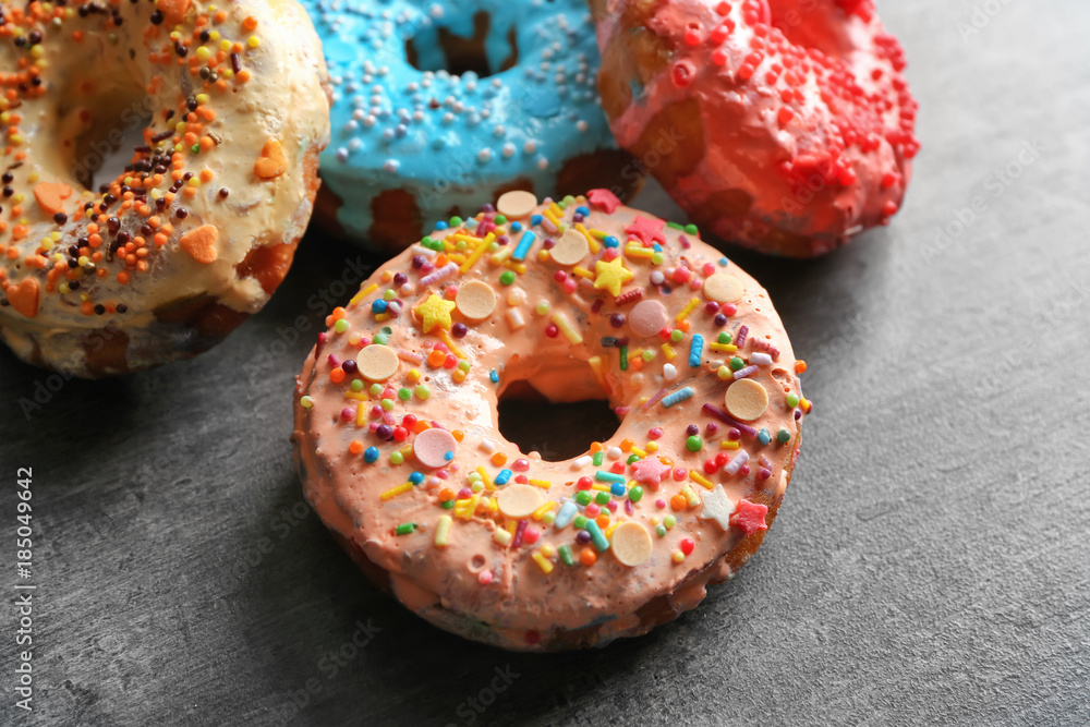 Fresh yummy colorful donuts on grey background Fresh yummy colorful donuts on grey background