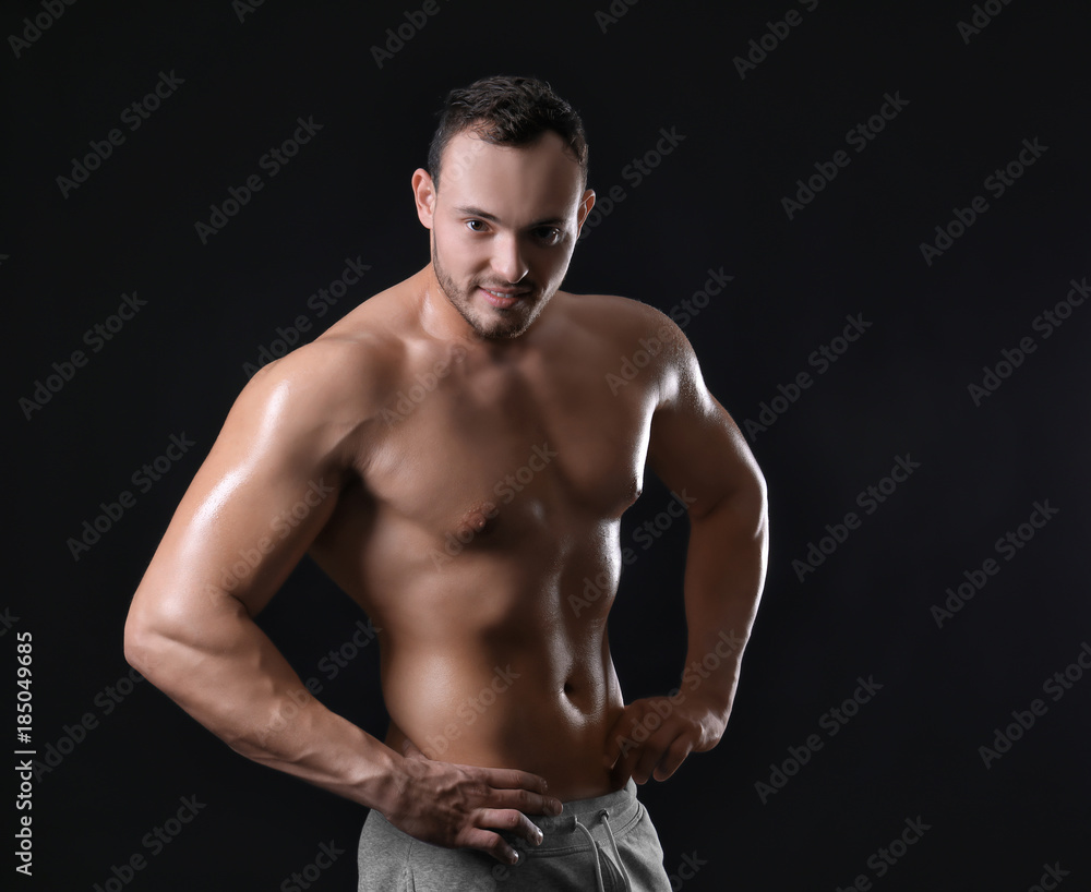 Muscular young bodybuilder on dark background Muscular young bodybuilder on dark background