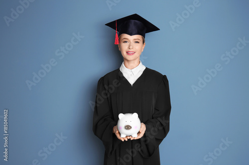 Young graduate holding pigg...
