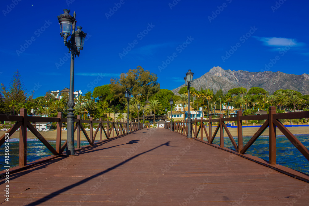 Pier. Wooden pier in Marbella. Malaga province, Costa del Sol, Andalusia, Spain. Picture taken – 14 december 2017.