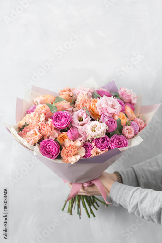Fototapeta Naklejka Na Ścianę i Meble -  beautiful luxury bouquet of mixed flowers in woman hand. the work of the florist at a flower shop.