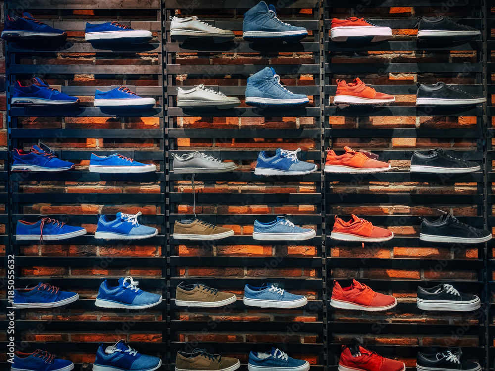 Lots of different sneakers on the showcase on market. Image of sport shoes  on shop-window Stock Photo | Adobe Stock
