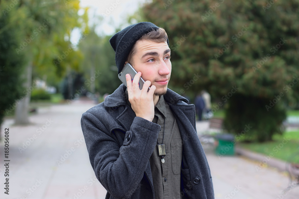 Handsome teenager talking on a mobile phone. Handsome teenager talking on a mobile phone.