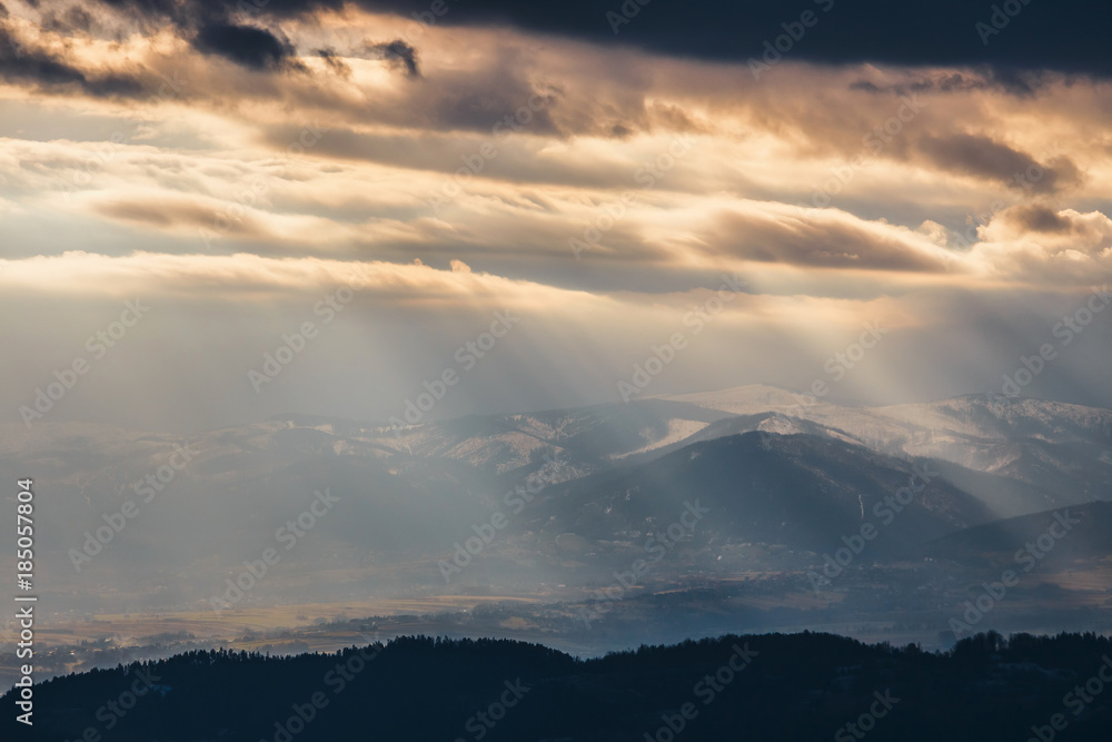 Rays of light pass through the clouds, mountain landscape