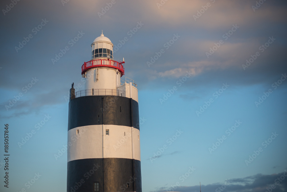 Hook Head lighthouse in Wexford, Ireland at sunset