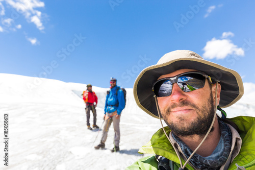 Three alpinists friends walking climbing ice glacier mountain Andes Peru