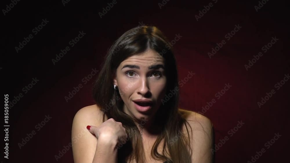 Beautiful long-haired brunette is surprised and shows a finger at herself, slow motion Beautiful long-haired brunette is surprised and shows a finger at herself, slow motion