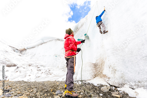 Two alpinists guys climbing training ice glacier wall Andes Peru