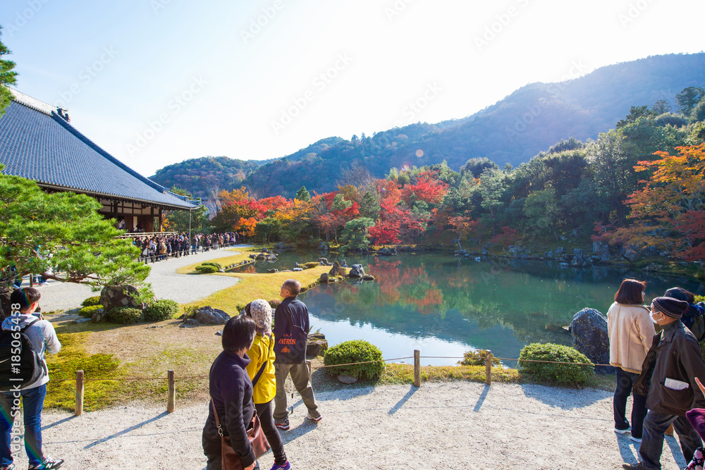 Tourists enjoy travel to Sogenchi pond garden in autumn season at Tenryuji temple