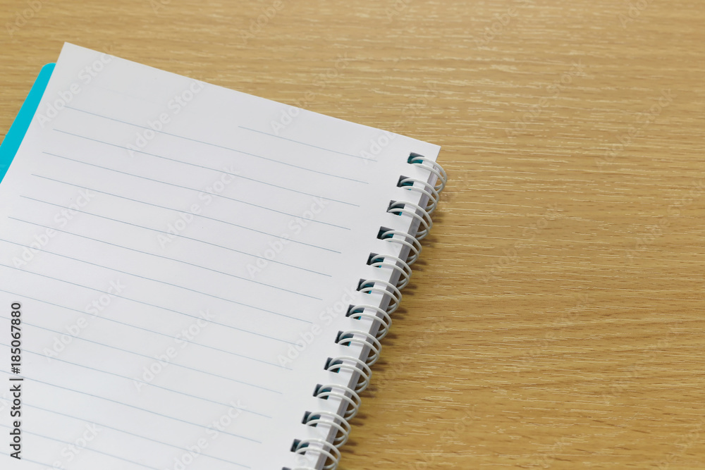 Blank notebook placed on a brown wood floor. Blank notebook placed on a brown wood floor.