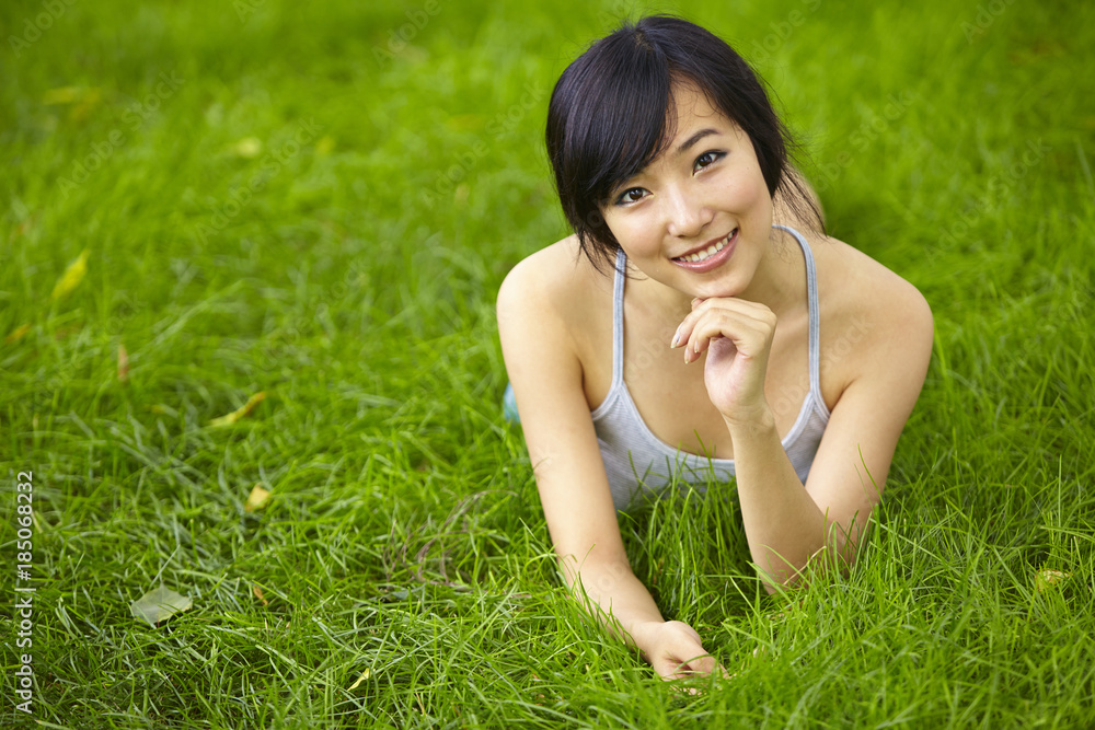 pretty young asian woman relax on grassland pretty young asian woman relax on grassland