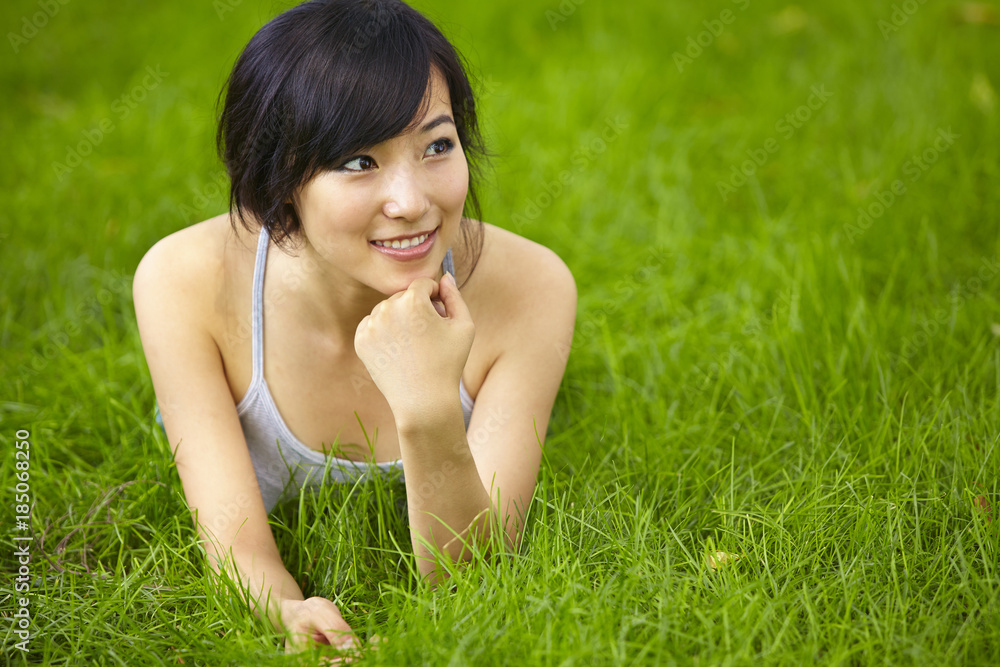 pretty young asian woman relax on grassland pretty young asian woman relax on grassland