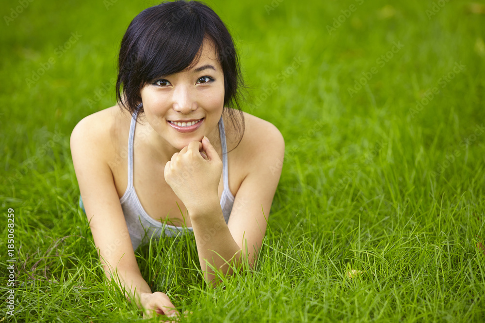 pretty young asian woman relax on grassland pretty young asian woman relax on grassland