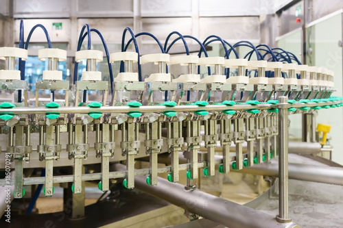 bottle filling, beverage bottles filled with beverage by an industrial machine in a beverage factory