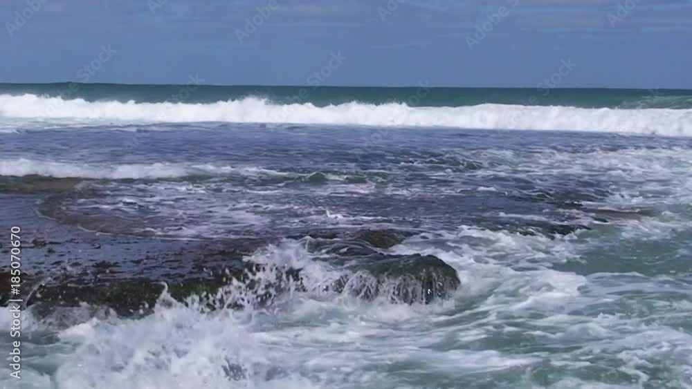 A full shot of a seashore and waves with sky A full shot of a seashore and waves with sky