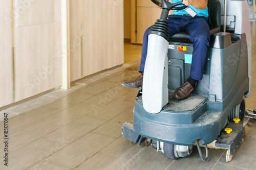 Canvas Print unidentified man operates rider floor Scrubber Machine at supermarket