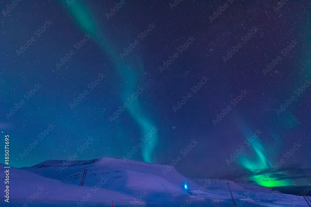 The polar arctic Northern lights aurora borealis sky star in Norway Svalbard in Longyearbyen city the moon mountains