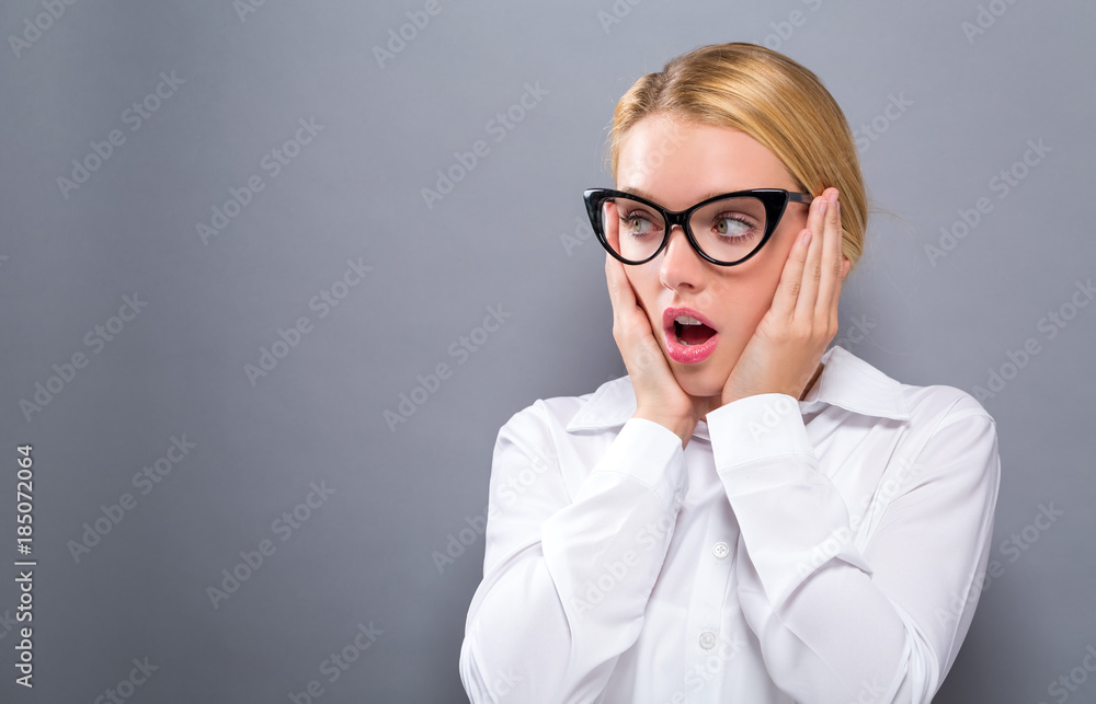 Surprised young woman posing on a solid background Surprised young woman posing on a solid background
