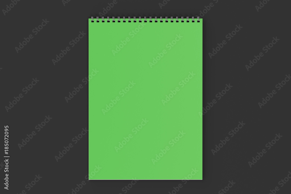 Blank green notebook with metal spiral bound on black background Blank green notebook with metal spiral bound on black background