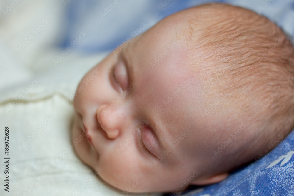 Newborn baby slepping wearing knitted overall Newborn baby slepping wearing knitted overall
