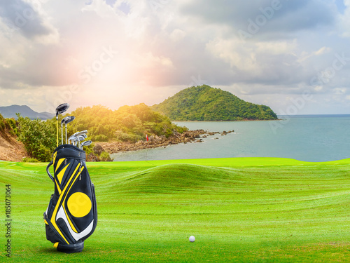 golf equipment on green and hole as background.