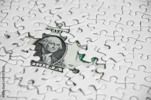 Missing jigsaw puzzle pieces on money dollar background, Business solution concept ,key for success