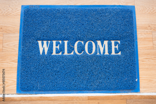 Welcome mat on the floor background.