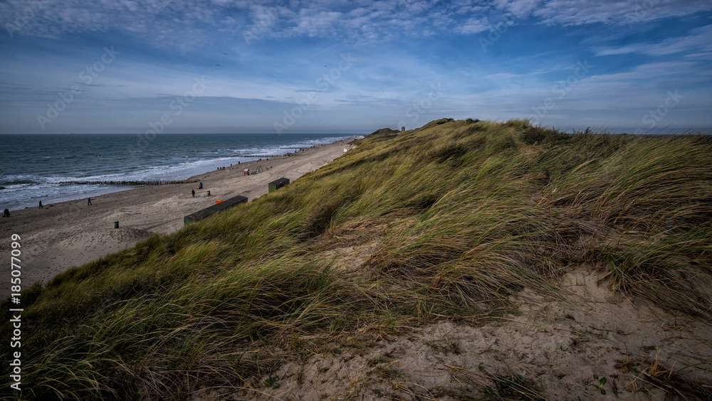 Beautiful view on sandy dunes and blue cloudy sky near Vlissingen, Zeeland, Holland, Netherlands
