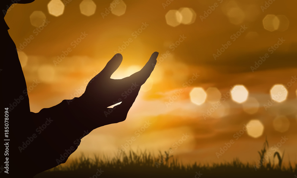 Obraz premium Silhouette of human hand with open palm praying to god