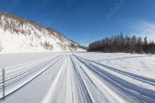 winter road on the frozen river bed