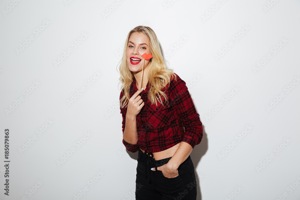 Young pretty woman holding fake lips Young pretty woman holding fake lips