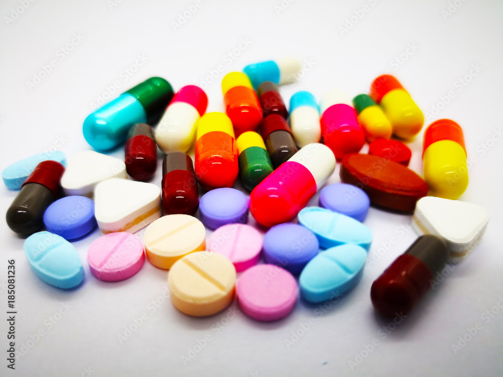 Many colorful pills, tablets and capsules medicinal drug, isolated on white background. Selective focus. Many colorful pills, tablets and capsules medicinal drug, isolated on white background. Selective focus.