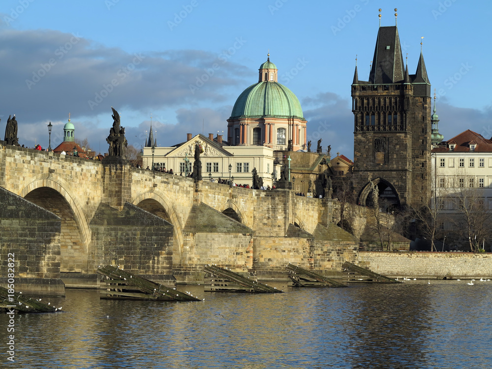PRAGUE, CZECH REPUBLIC - DECEMBER 10, 2016: The Charles bridge and Old Town Tower PRAGUE, CZECH REPUBLIC - DECEMBER 10, 2016: The Charles bridge and Old Town Tower
