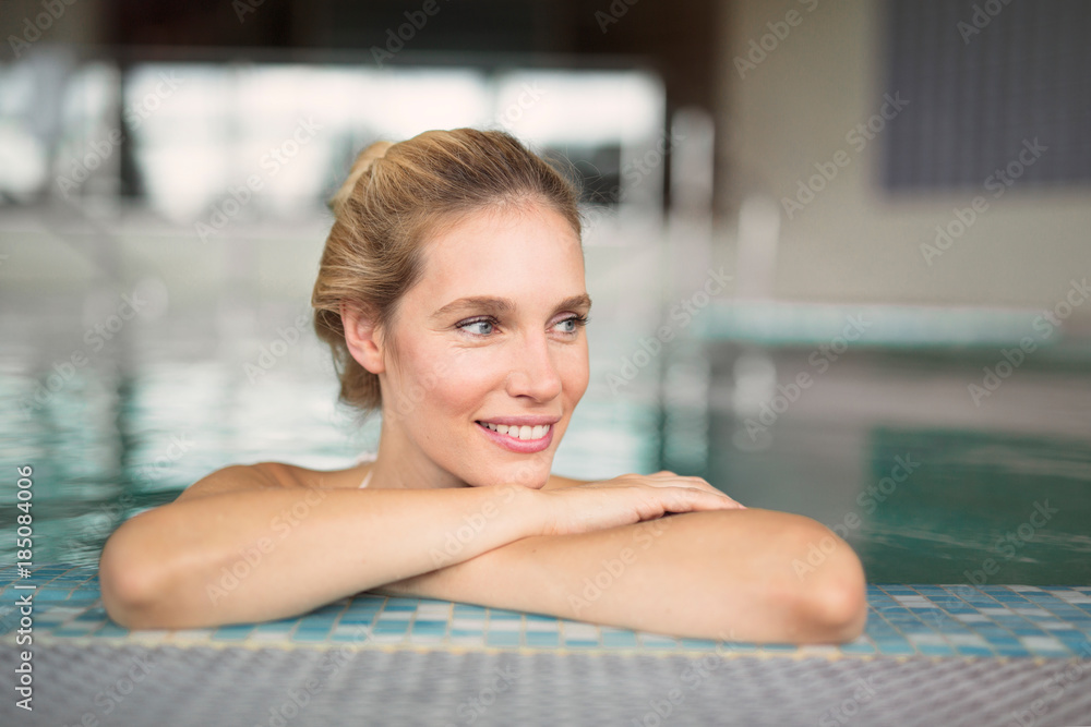 Portrait of beautiful woman relaxing in swimming pool