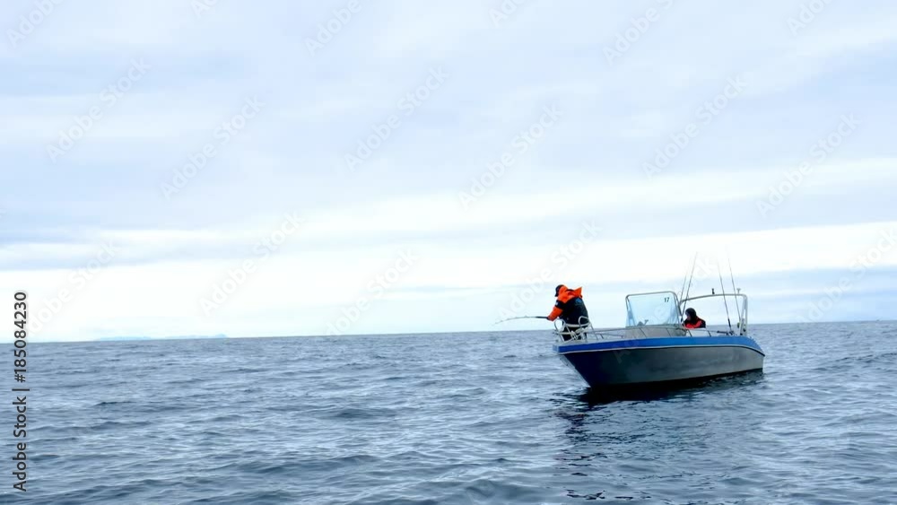 Man in Florida catching King fish from boat. Man in Florida catching King fish from boat.