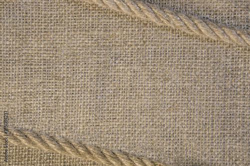 Texture of burlap with cord rope. Template frame of coarse cloth background
